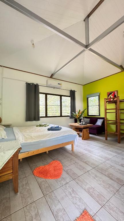 a bedroom with a large bed in a room at Similan Home Stay in Ban Lam Ru (1)
