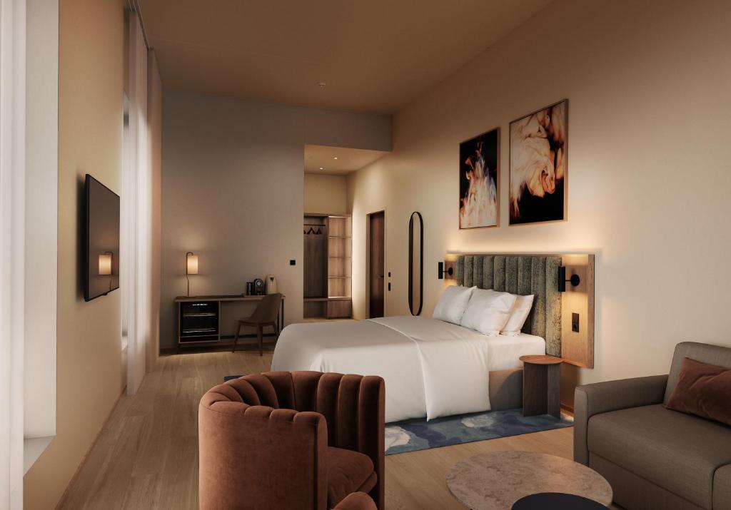 a hotel room with a bed and a couch at Thon Hotel Drammen in Drammen