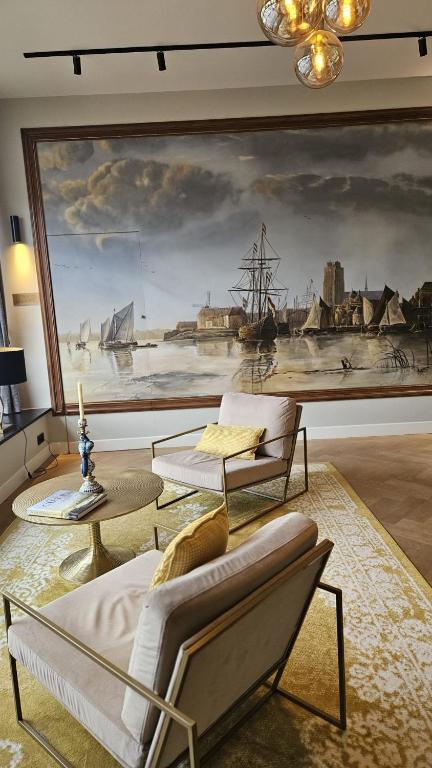 a living room with a large painting on the wall at Nieuwe Haven 23 in Dordrecht