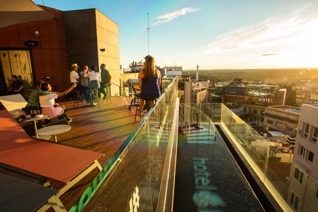 a group of people standing on top of a building at Hotel Indigo Madrid - Gran Vía by IHG in Madrid