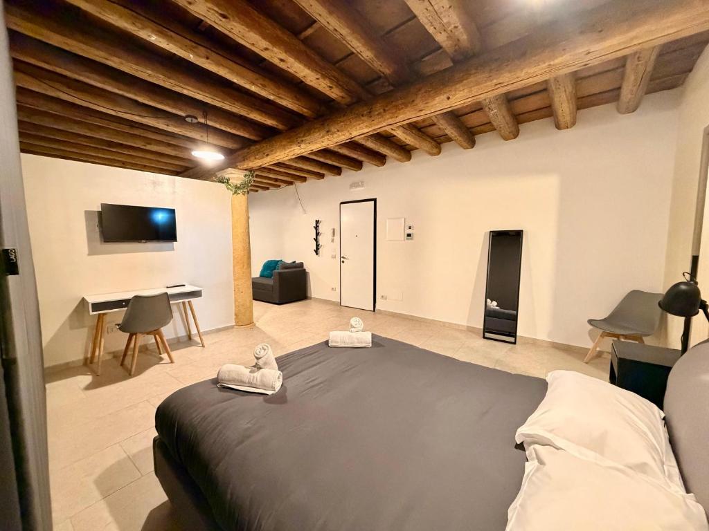 a bedroom with a large bed and a living room at Palazzo Giulietta in Verona
