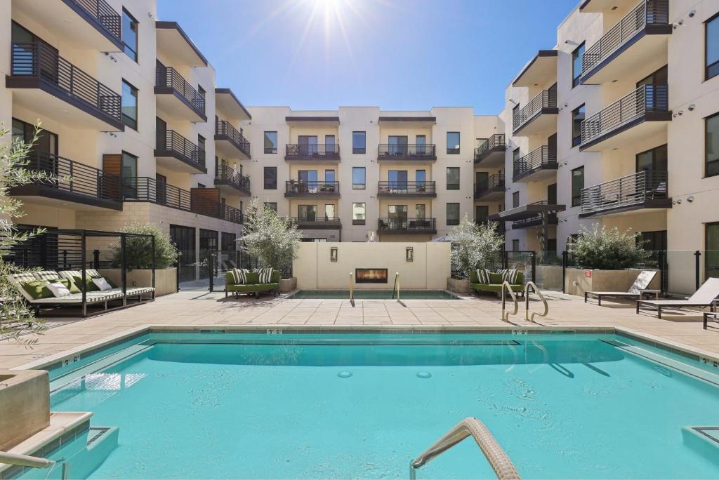 a swimming pool in front of an apartment complex at Sentral Old Town in Scottsdale