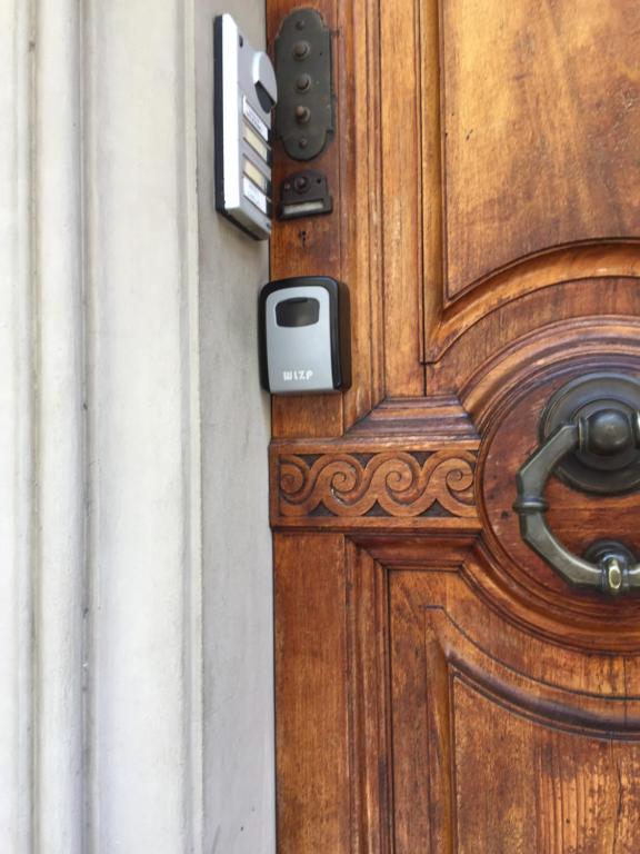 a close up of a wooden door with a latch at Via Roma 131 in Montevarchi
