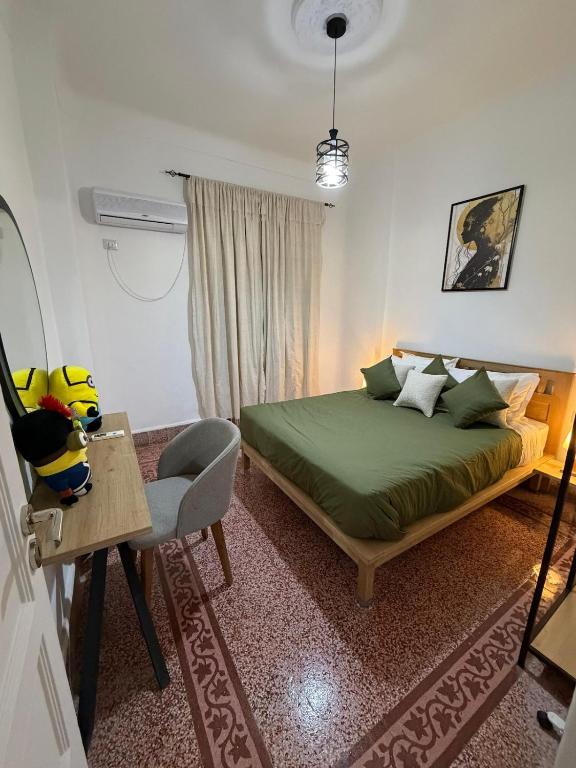 a bedroom with a bed and a table and a chair at Casa Shala in Tunis