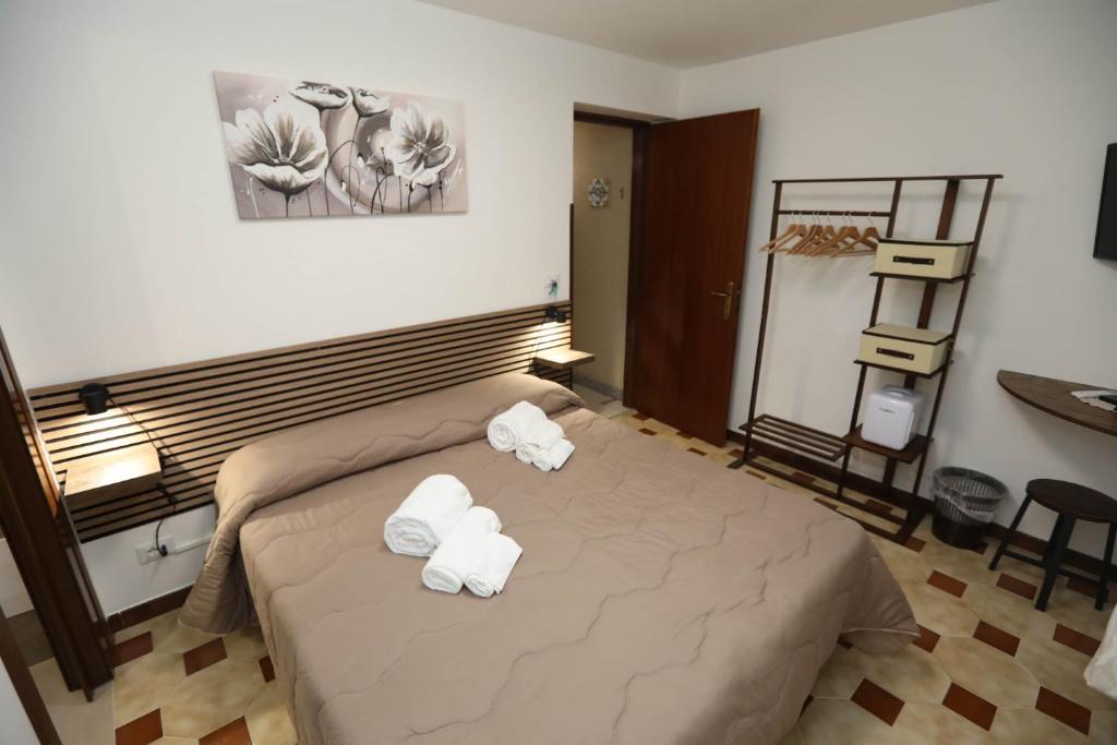 a bedroom with a bed with towels on it at Pianofilecciarooms in Salemi