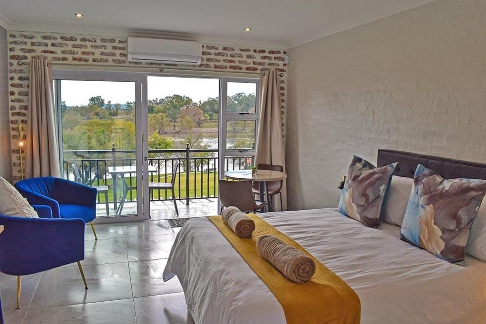 a bedroom with a large bed and a balcony at 1009 Studio Apartment Pont de Val in Parys