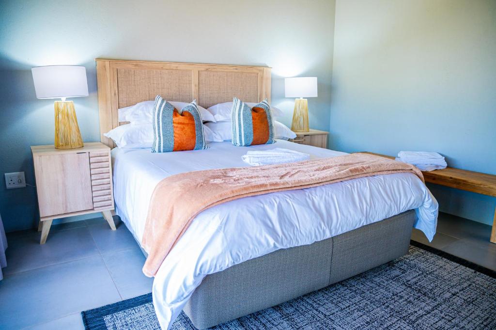 a bedroom with a large bed with two night stands at Collen Pillar Hotels, Windsor Royale in Athol