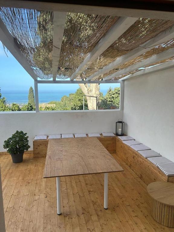 a large room with a table and a large window at Dream on the Blue House in Valderice