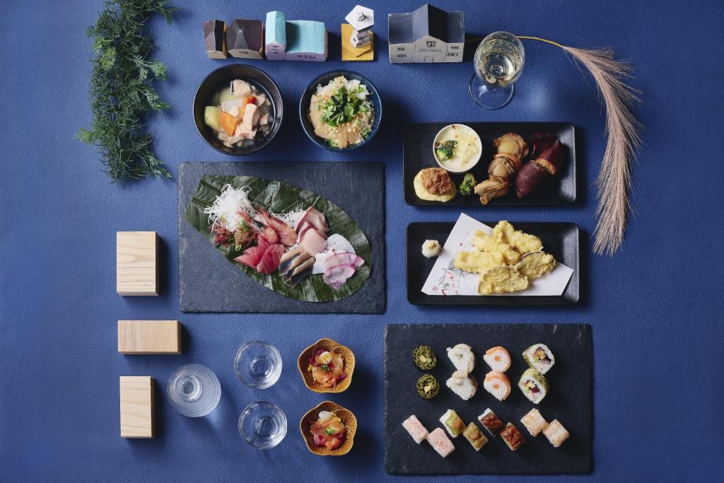 a bunch of plates of food on a blue table at Hakodate Hotel Banso in Hakodate