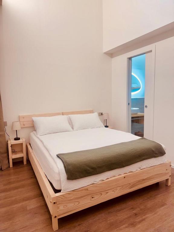 a bedroom with a large bed with a window at B&B Morbegno in Morbegno