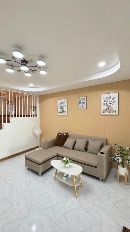 a living room with a couch and a table at Mnp home in Chiang Rai