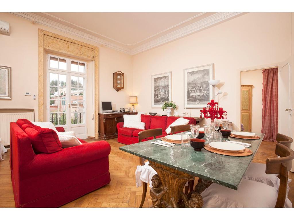 a living room with red chairs and a table at Apartment Margutta in Rome