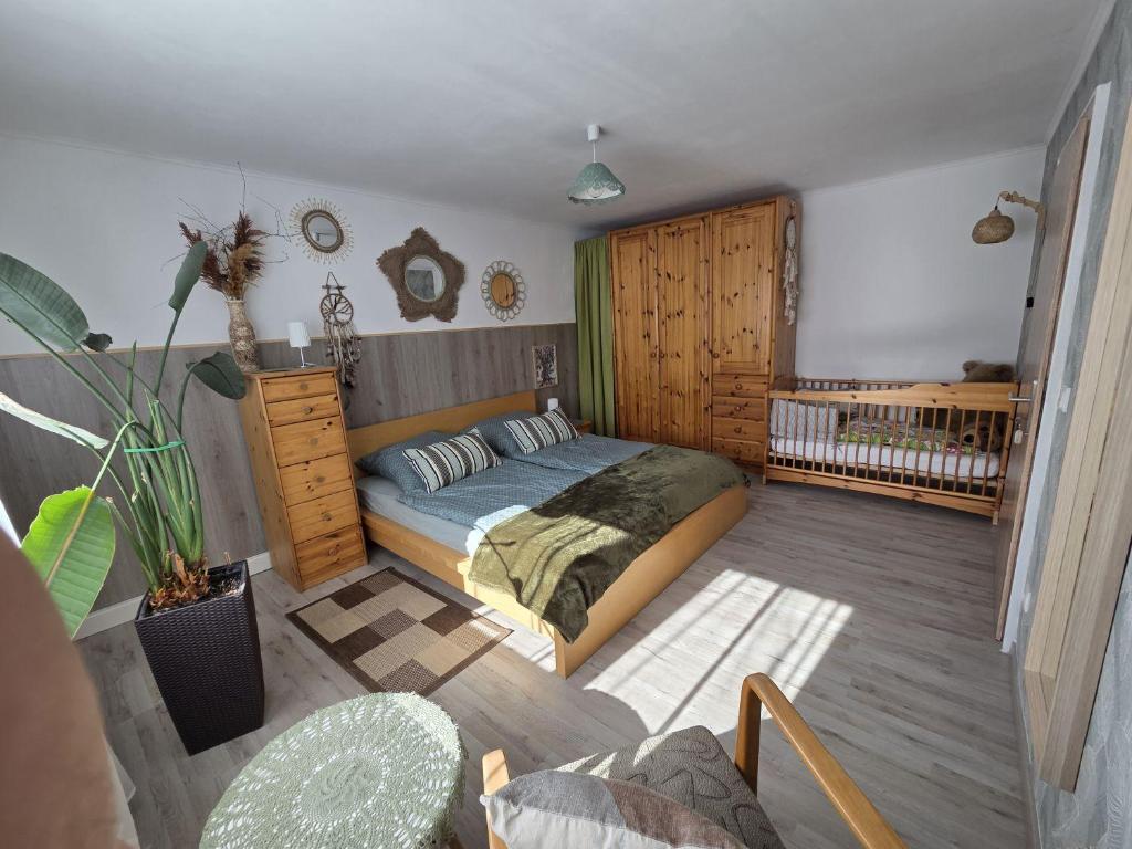 a bedroom with a bed and a crib at Ferienwohnung Waldbach in Arrach