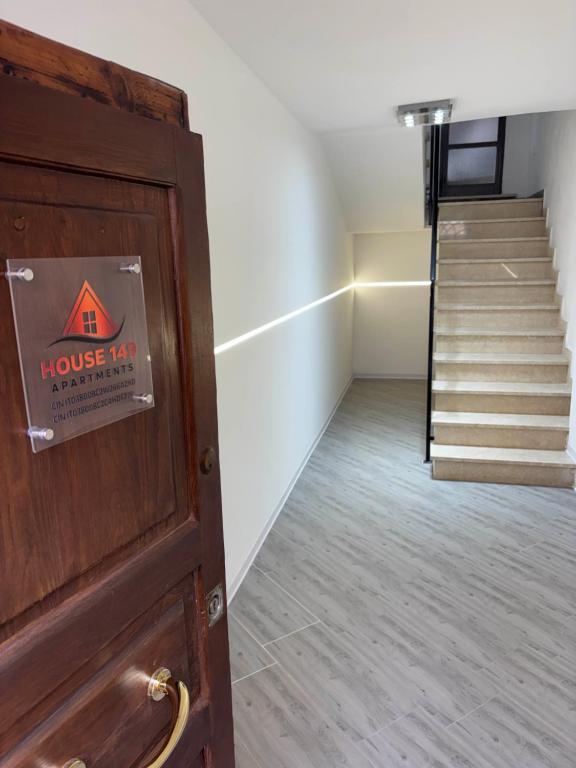 a room with a door with a staircase in the background at House 149 in Ferrara