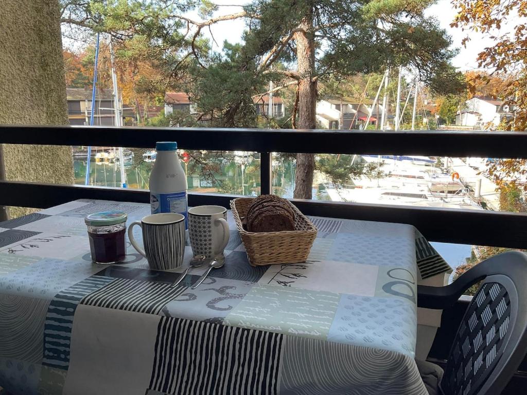 a table with a basket and a bottle of milk at La Mouette de Ripaille in Thonon-les-Bains