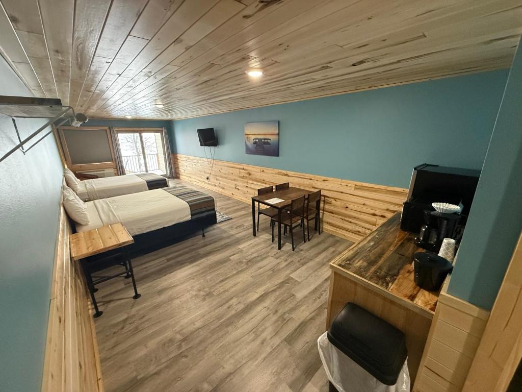a bedroom with a bed and a desk in a room at Cass Lake Lodge in Cass Lake