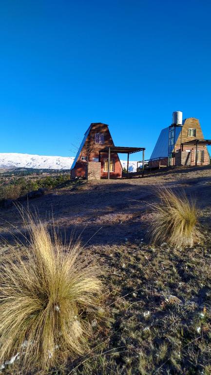 an old barn in the middle of a field at Ventana al Champaqui in Yacanto
