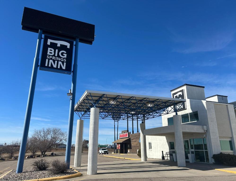 a large building with a sign in front of it at Big Springs Inn in Big Springs