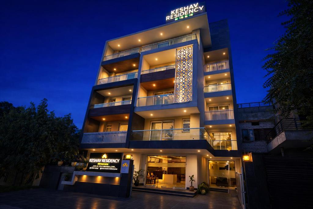a tall building with a christmas tree on it at Hotel Keshav Residency - Medicity Gurugram, near Medanta Hospital, Pure Vegetarian in Gurgaon