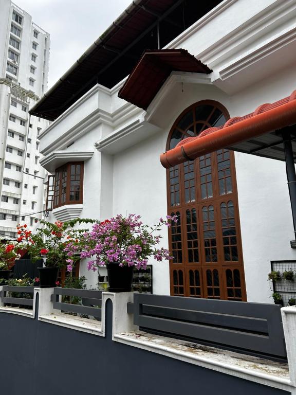 a building with potted plants on a balcony at Metro Bliz Alua by thestaypoint in Alwaye