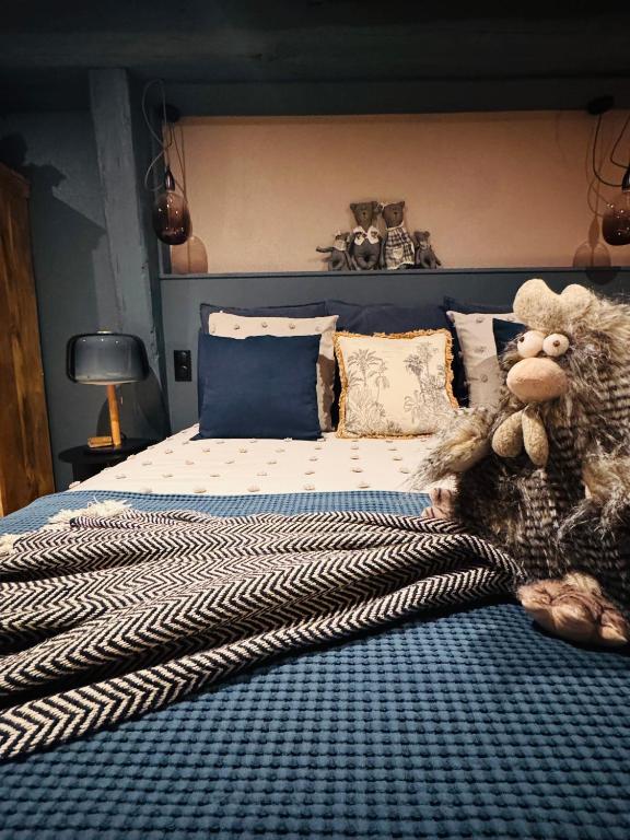 a bedroom with a bed with a monkey on it at Suite Richovilare - Sauna & Hammam in Riquewihr