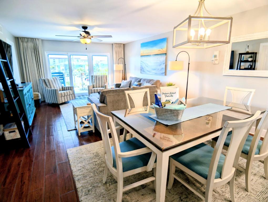 a dining room and living room with a table and chairs at Gulf Balcony - Boutique Comforts & 2 King Suites in Fort Walton Beach
