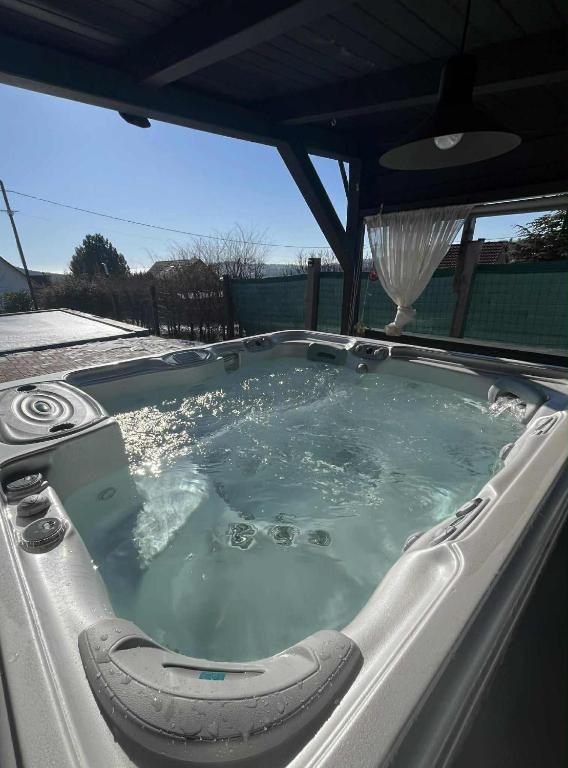 a jacuzzi tub with a chair in it at Shining Home in Felsőörs