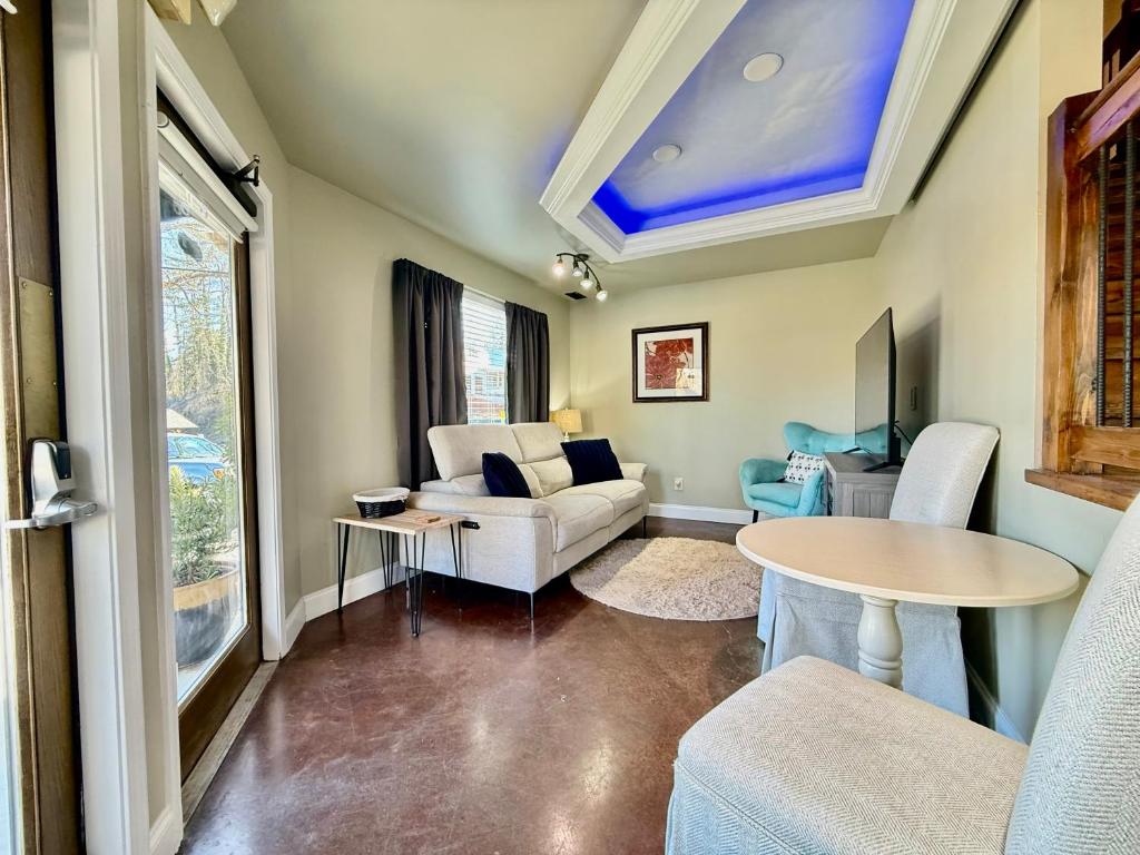 a living room with a couch and a table at Haven at Hazel - the Residence in Demorest