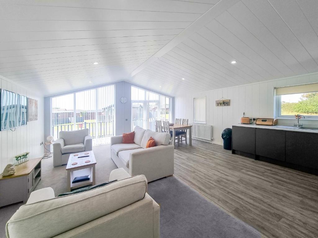 a living room with two couches and a kitchen at Cherry Blossom 39 - Uk50708 in Garton