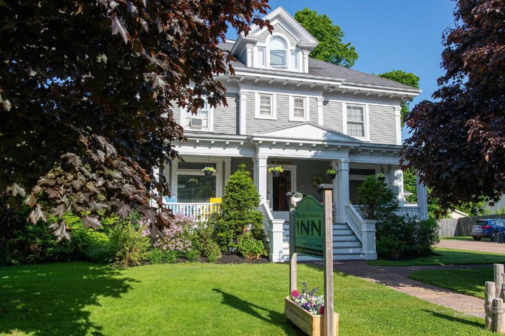 a house with a yard sign in front of it at The Boardwalk Inn in Summerside