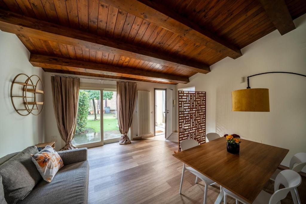 a living room with a wooden table and a couch at Urban Nest in Forlì