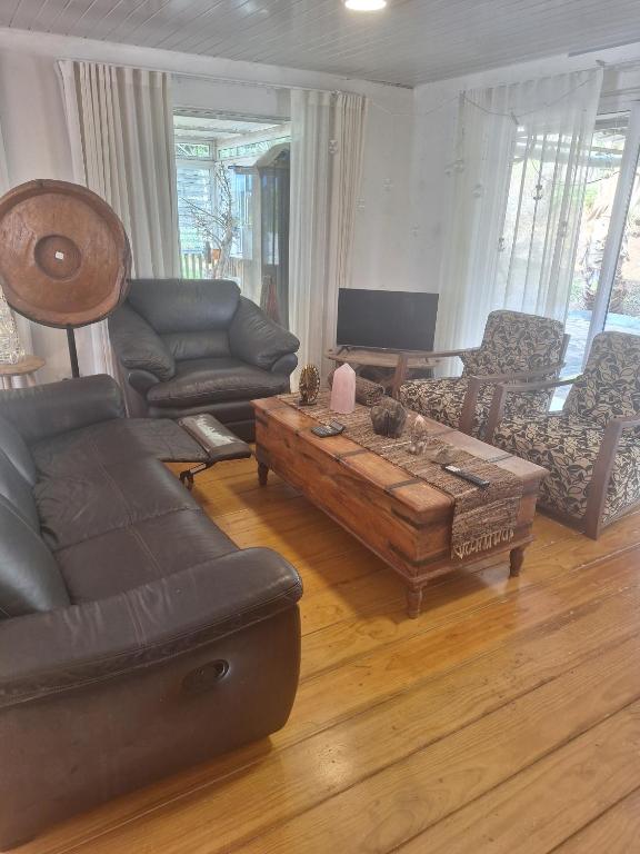 a living room with a couch and a coffee table at Pieter Both Mountain Lodge in La Laura