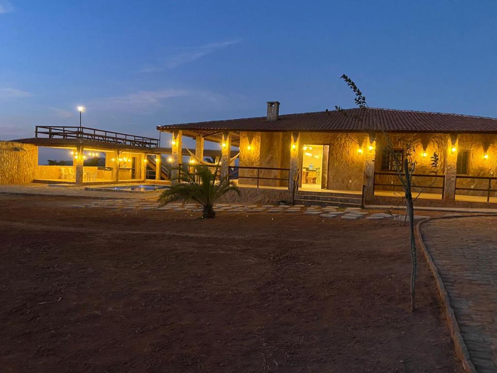 a building with lights in front of it at night at Recanto do tdias in Mulungu