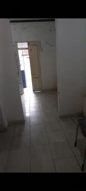 an empty room with a door and a tile floor at Casa em Bezerros in Bezerros