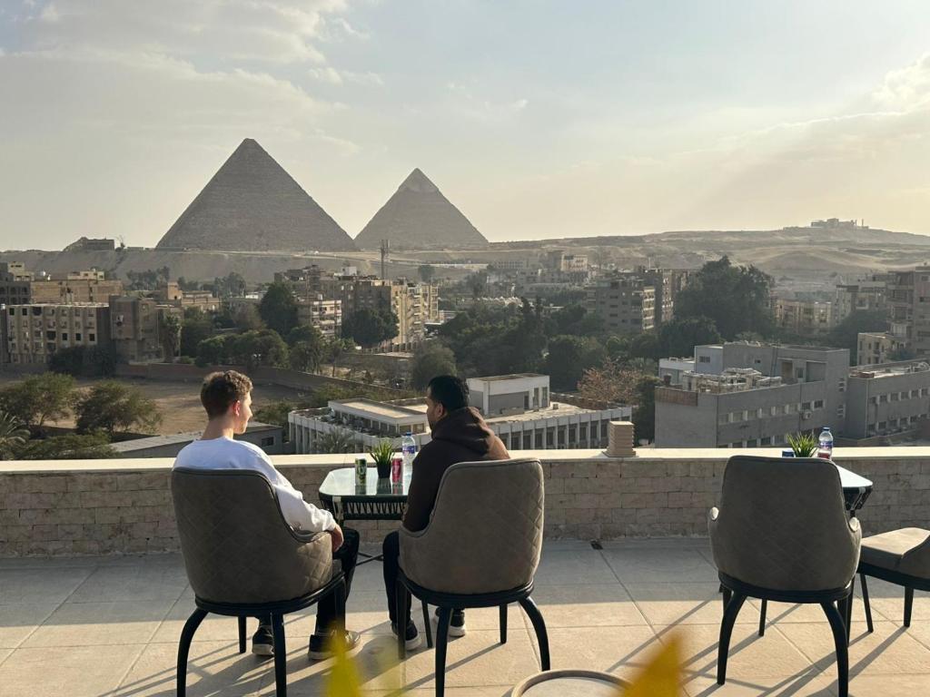 two people sitting at a table overlooking the pyramids at New City Plaza in Cairo