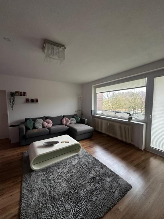 a living room with a couch and a rug at Bright & Spacious 1BR Apartment in Bielefeld
