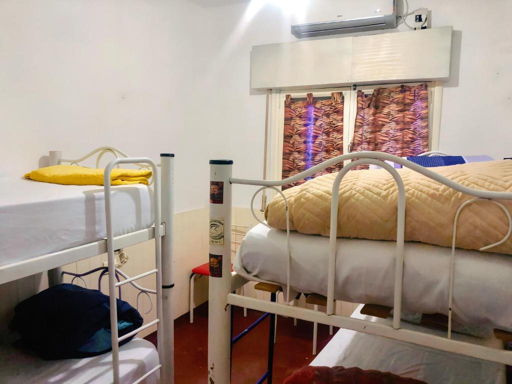 a room with two bunk beds and a window at Hostel Base La Rioja in La Rioja