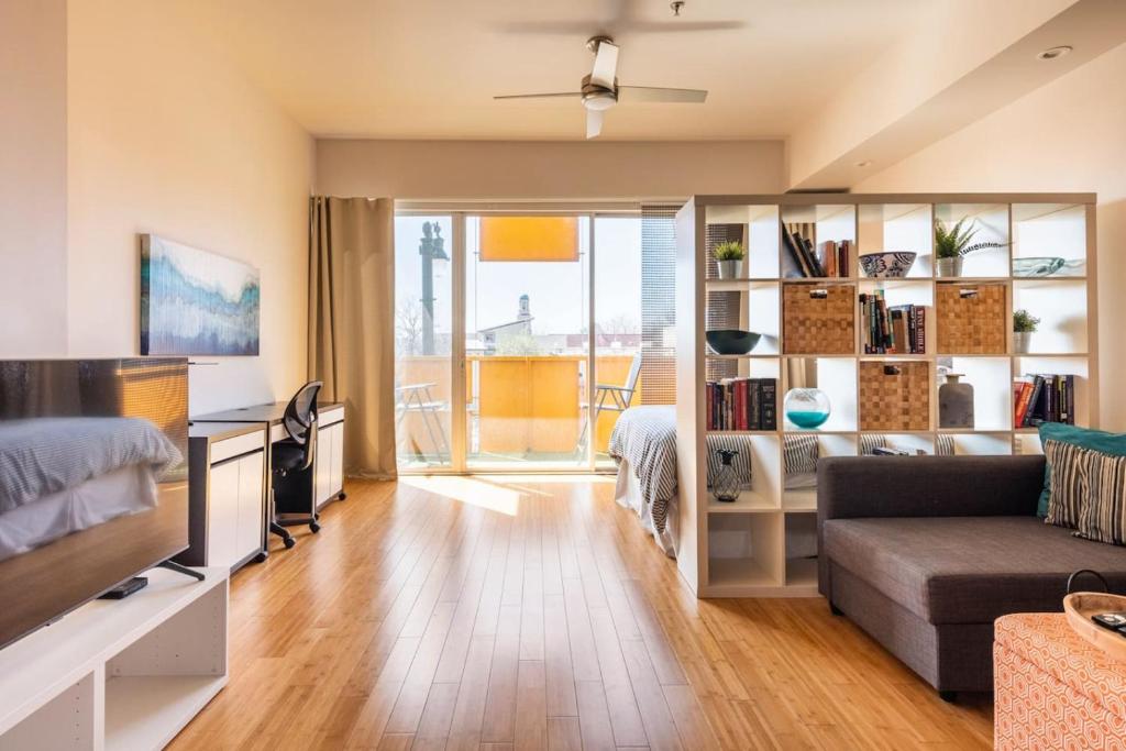a living room with a couch and a desk at Studio nr Town Lake and E6th w Balcony by Austin Vacay in Austin