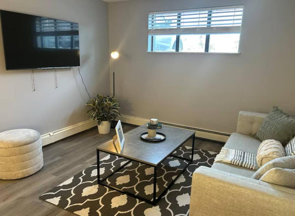 a living room with a couch and a coffee table at Spacious and cute basement unit in Thunder Bay