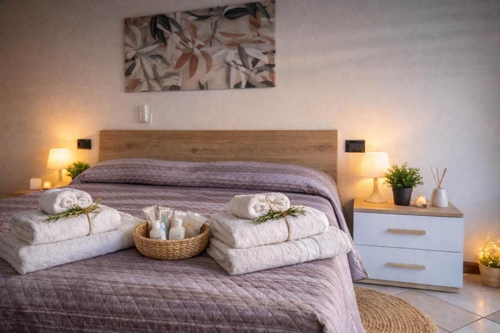 a bedroom with a bed with towels on it at Ca Linda By Case al Lago in Desenzano del Garda