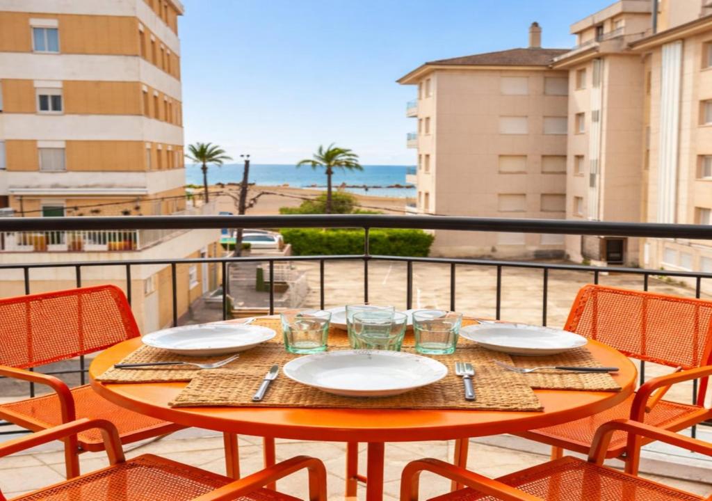 a table on a balcony with a view of the ocean at Beachfront apartment with sea views in Cunit