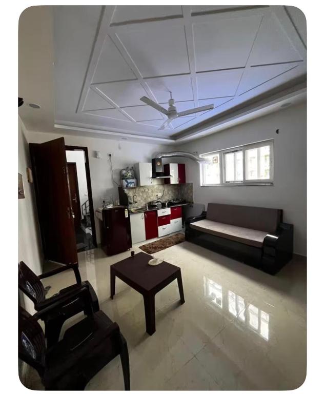 a living room with a couch and a table at E block in Rājpur