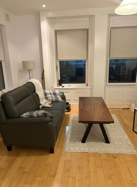 a living room with a couch and a coffee table at Clare Cottage in Doolin