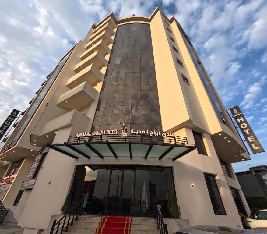 a tall building with stairs in front of it at Abraj Al Madina Hotel in Al Fayşalīyah