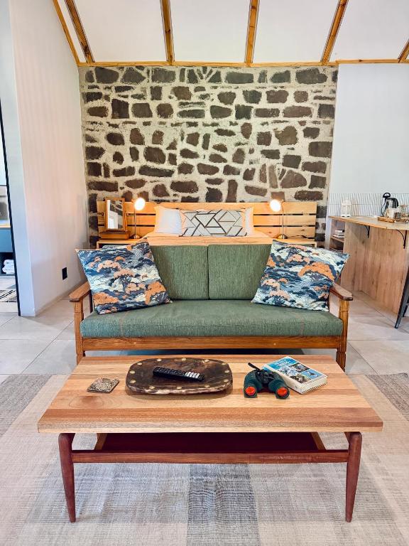 a green couch sitting on top of a coffee table at Mizpah Lodge in Bloemfontein