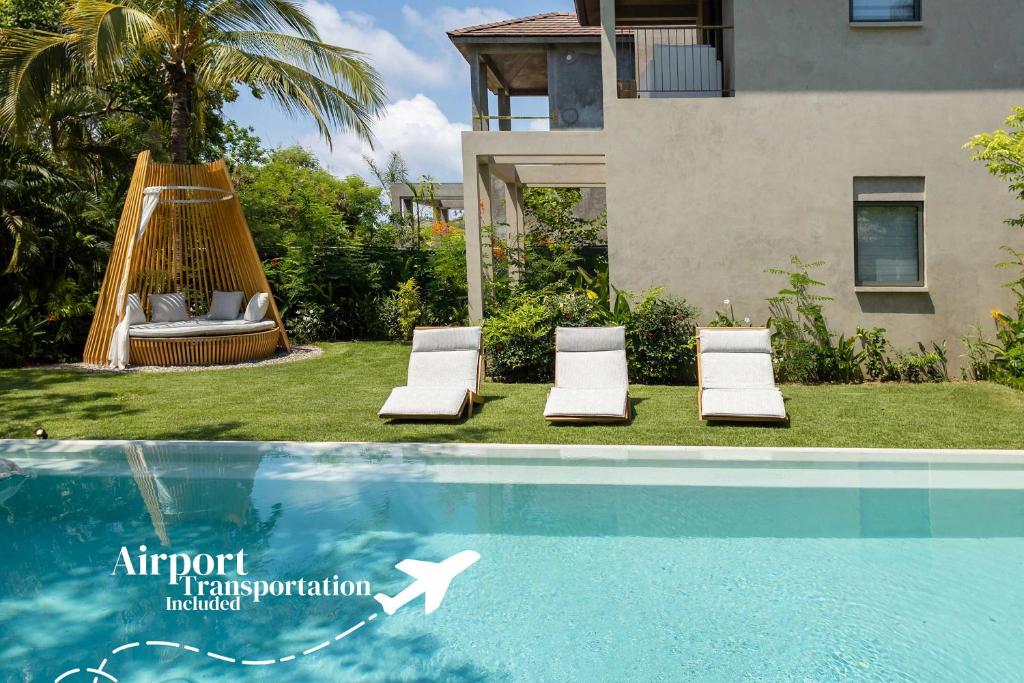 a hammock and two chairs next to a swimming pool at Luxury 5BR Villa with Pool Jacuzzi 2 Golf Carts in Punta Mita