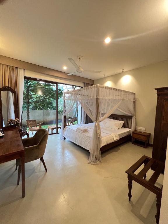 a bedroom with a bed with a canopy at Lumiere Villa, Kandy in Nugawela