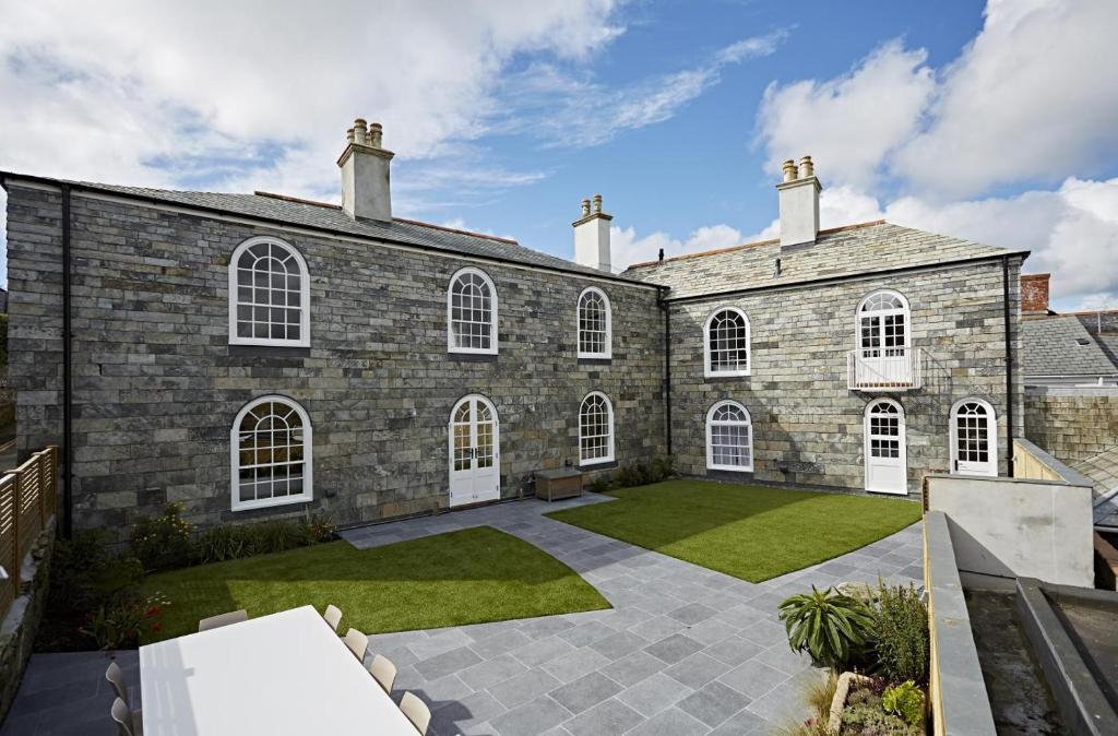 an exterior view of a large brick building with a courtyard at 6 Bed in Padstow oc-p00760 in Padstow