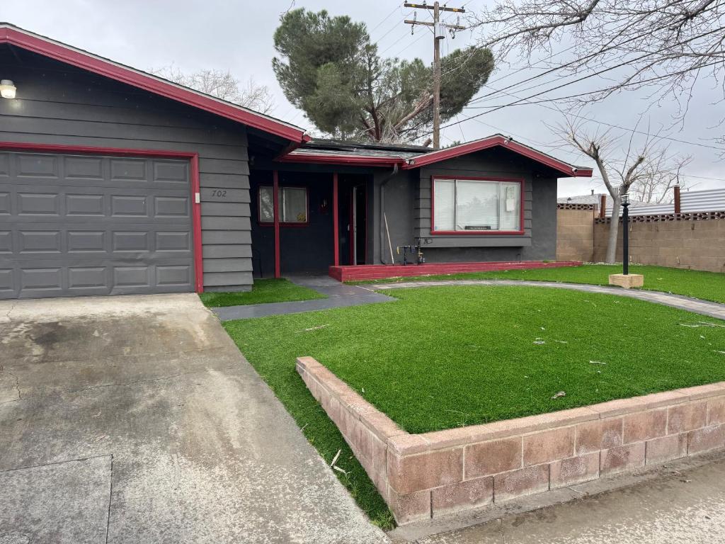 a house with a garage and a grass yard at Oldfield in Lancaster