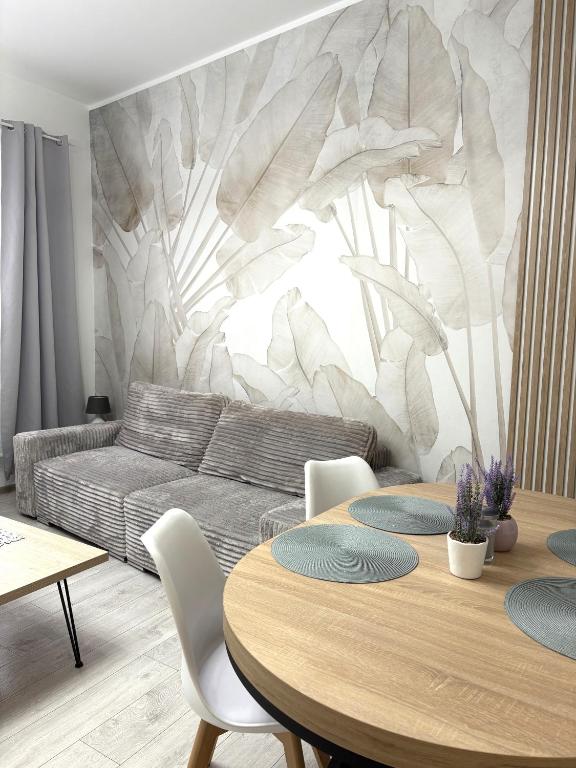 a living room with a couch and a table at Apartament Olesno in Olesno
